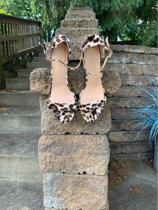 Women’s size 8.5 open-toe heels with leopard print straps and ankle buckle closure.