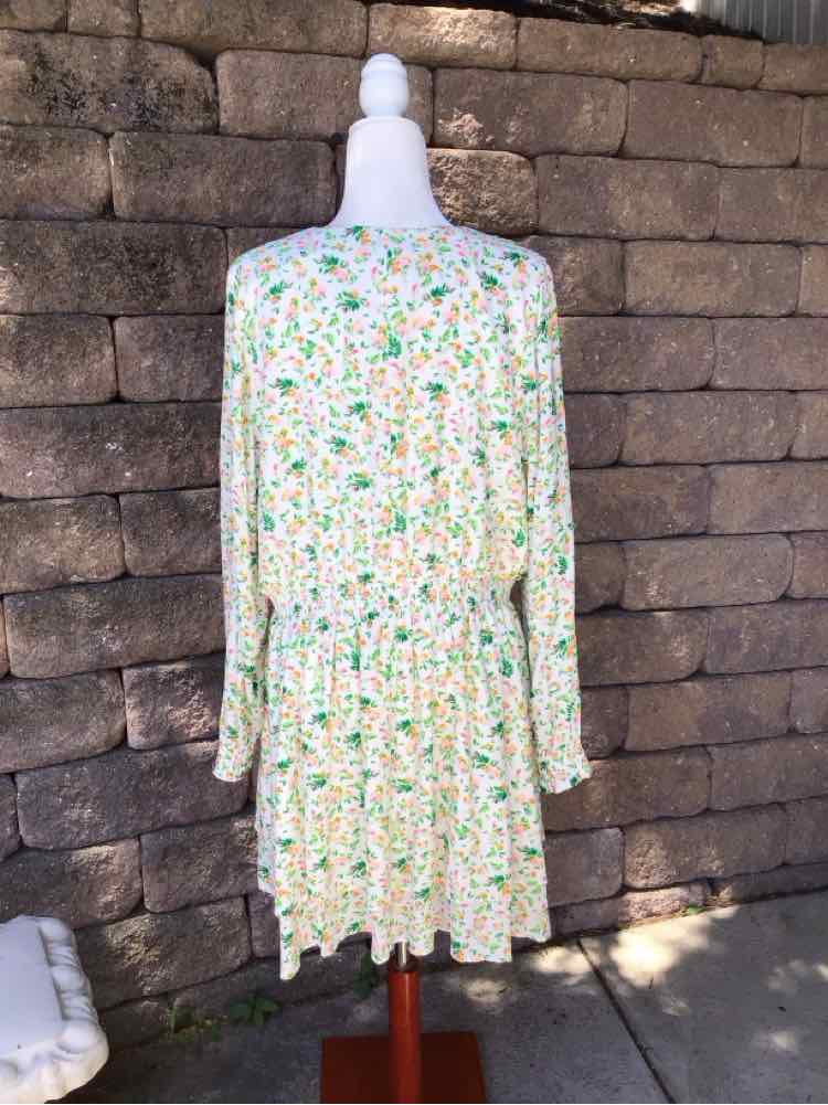 White floral long-sleeve dress with green and yellow flower print, elastic waist, and tiered skirt.