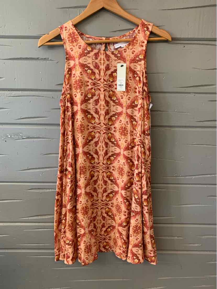 Sleeveless midi dress in warm cocoa with red paisley print and a round neckline.