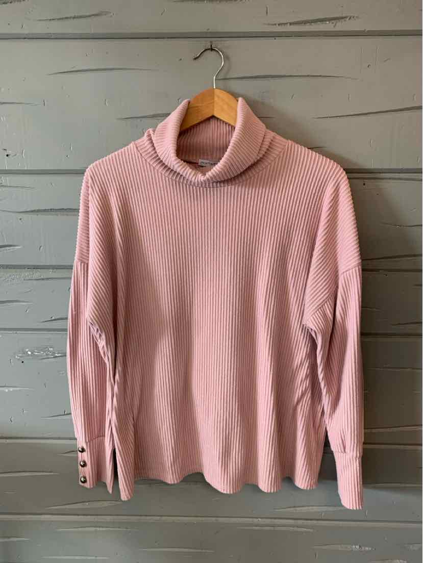 Light pink ribbed long-sleeve turtleneck sweater with button details on cuffs.