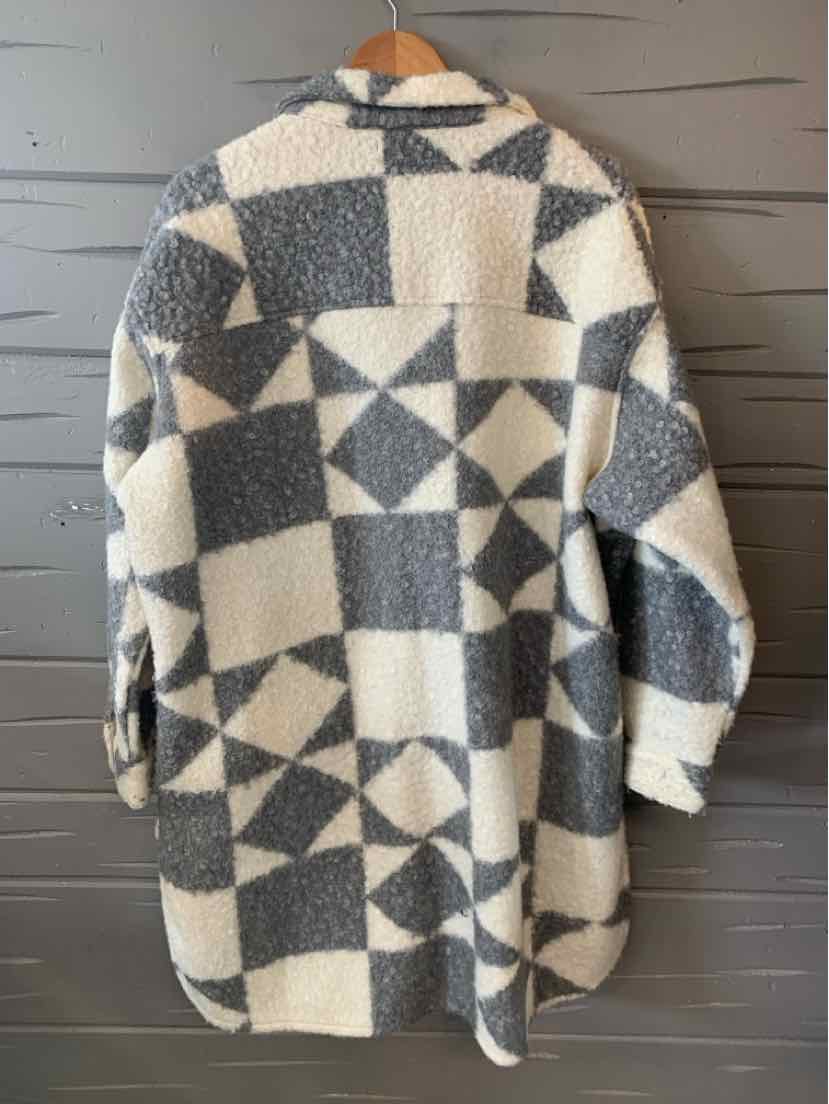 Long cozy sherpa jacket in gray and off-white geometric patchwork pattern with long sleeves and collar.