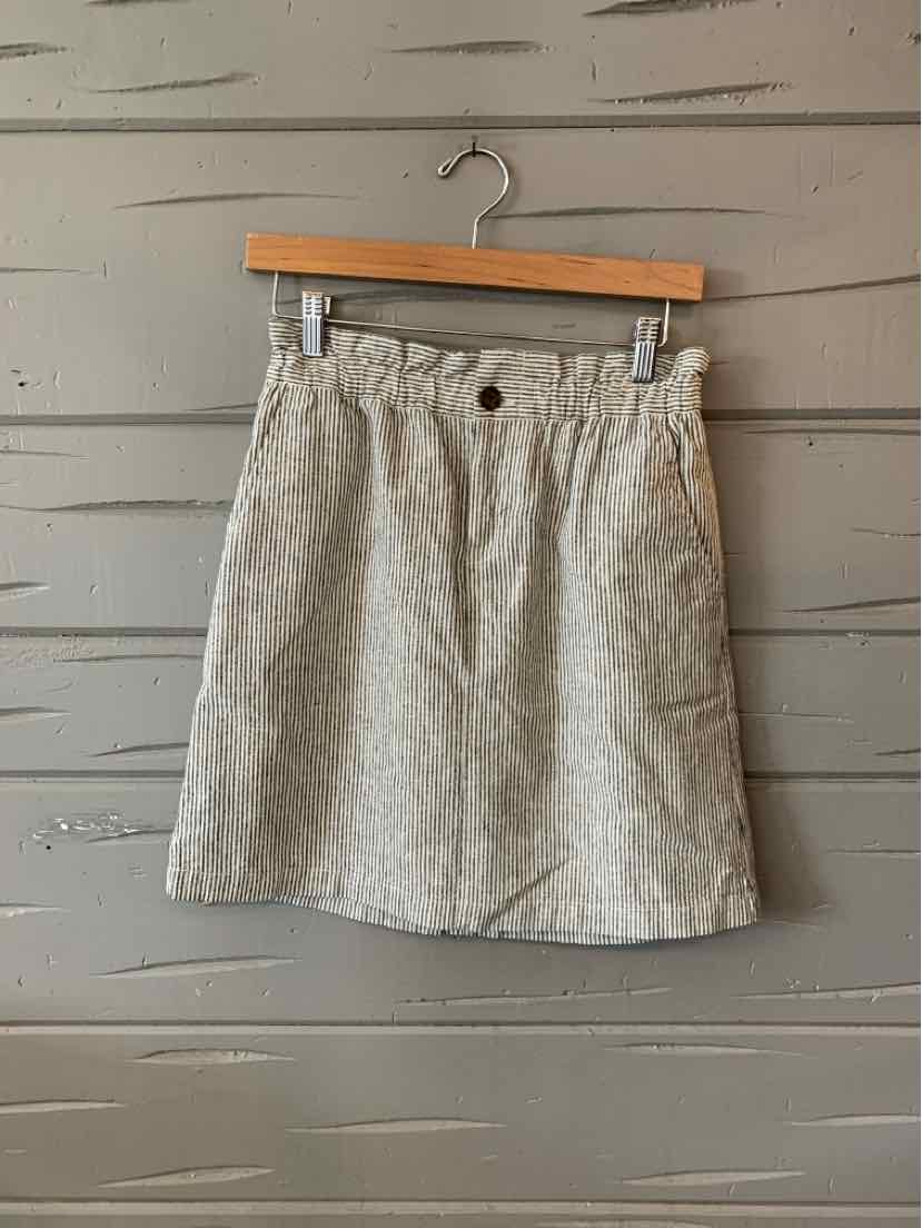 Light beige linen blend mini skirt with front button and elastic waistband.