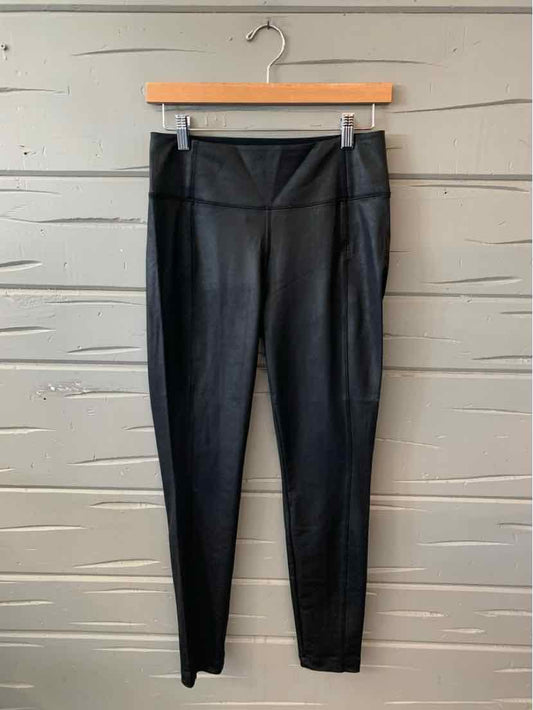 Black high-waist activewear apparel leggings for women with sleek, fitted design and stretchy fabric.