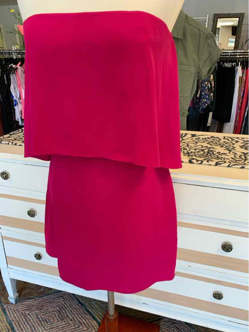 Fuchsia strapless mini dress with layered ruffle detail in a solid vibrant color.