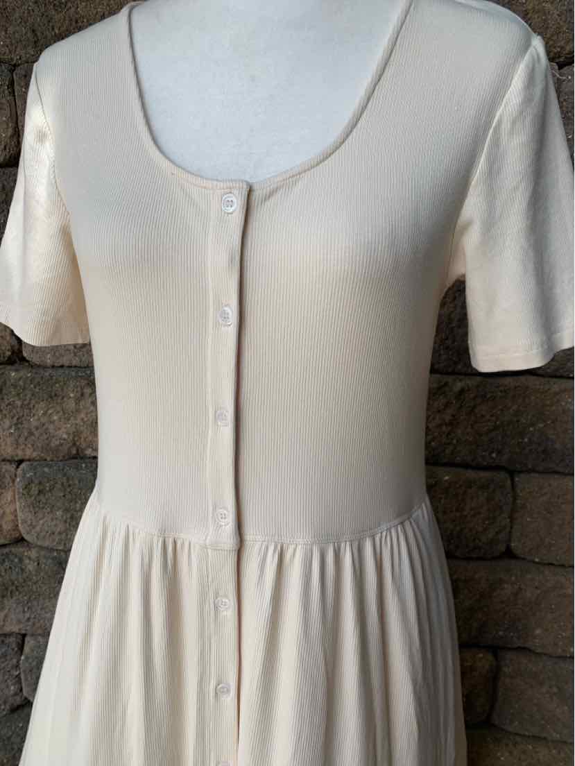 Cream short-sleeve dress with button-front closure and gathered waist detail.