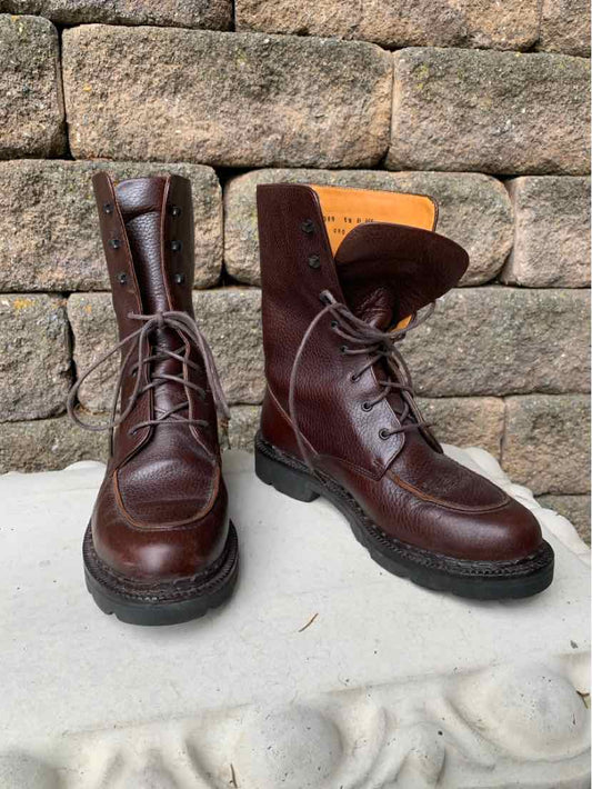 Dark brown leather lace-up boots with rugged black rubber soles and padded collars.