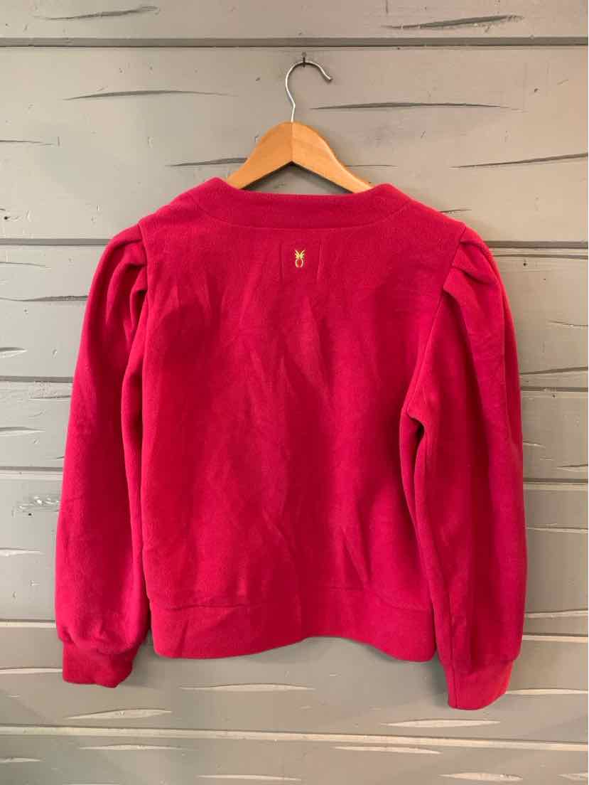Fuchsia fleece sweatshirt with long puffed sleeves and ribbed cuffs hanging on wooden hanger.