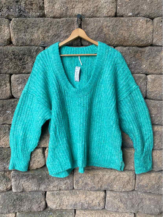 Teal chunky knit sweater with deep V-neck and balloon sleeves, relaxed fit, soft textured yarn.