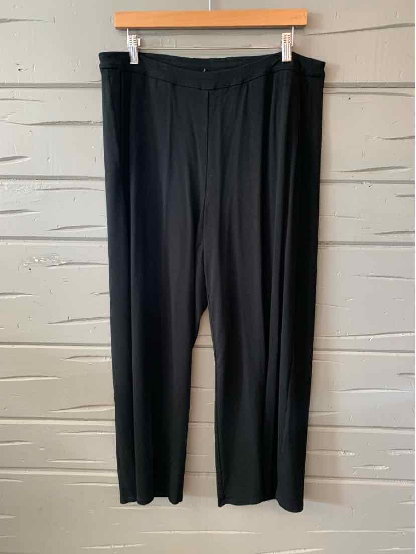 Black loose-fit women's pants with an elastic waistband, size XL, hanging on a wooden hanger.