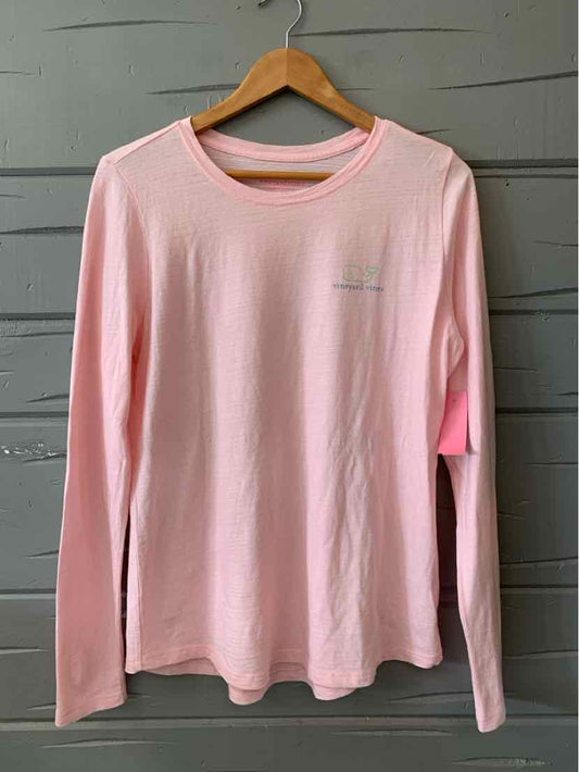 Light pink long-sleeve crewneck shirt with subtle logo on the chest, soft fabric.