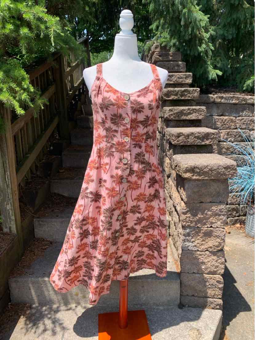 Pink tropical print sleeveless A-line dress with scoop neckline on mannequin.
