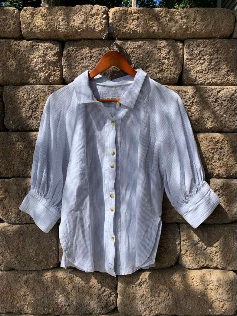 Light blue and white striped button-up shirt with rolled three-quarter sleeves and wooden buttons.