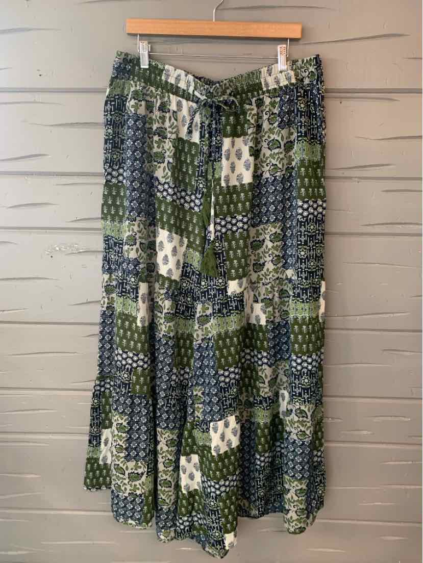 Green and blue patchwork maxi skirt with mixed geometric and floral patterns, elastic waistband.