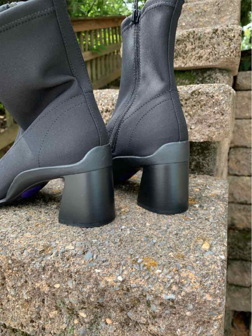Black mid-calf boots with block heels, stretchy fabric upper, and side zipper closure.