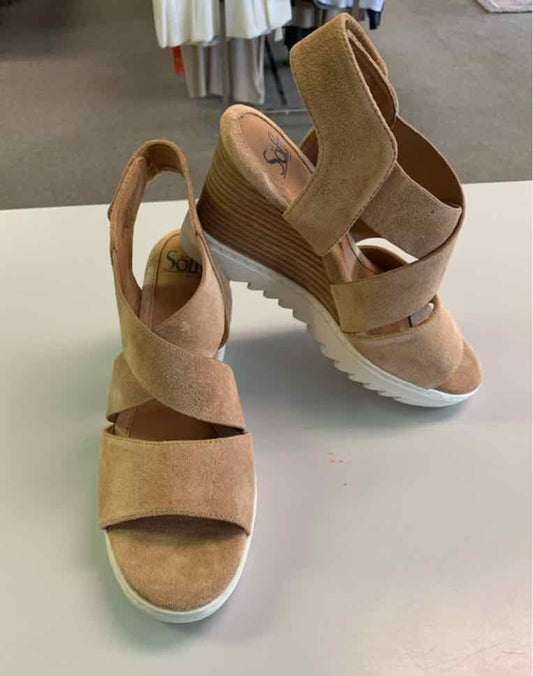 Tan suede wedge sandals with adjustable ankle strap and white rubber sole, size 8.5.