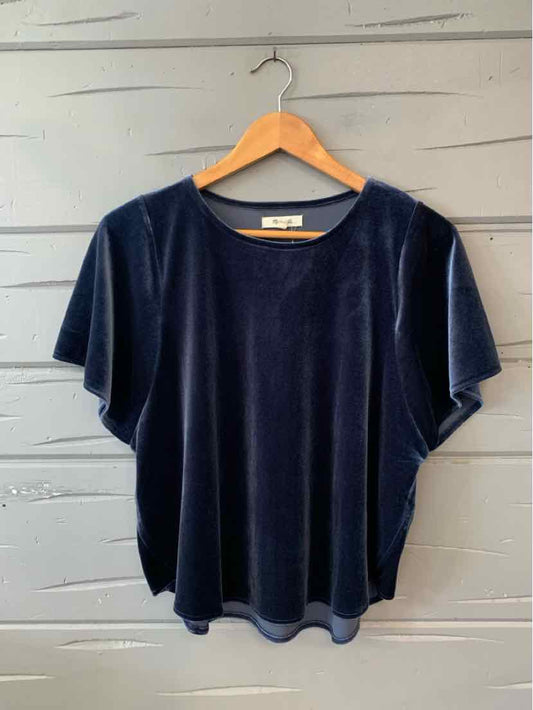 Navy blue velvet short-sleeve blouse with relaxed fit on wooden hanger.