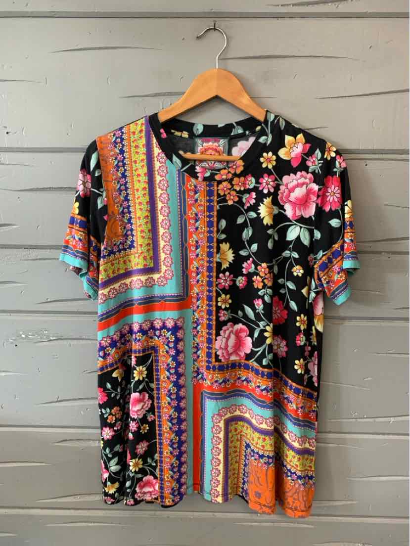 Short-sleeve cotton top with mixed floral and geometric patterns in black, pink, orange, and turquoise.