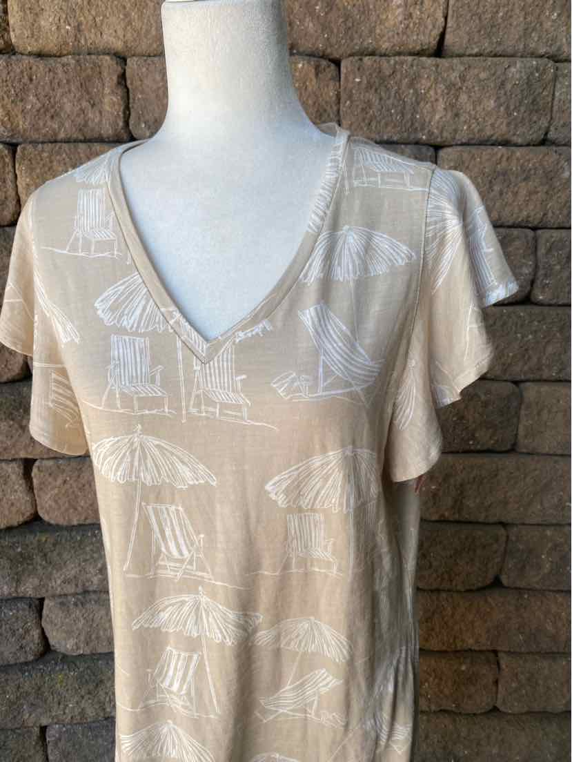 Tan V-neck short-sleeve shirt with white abstract geometric print on soft fabric.