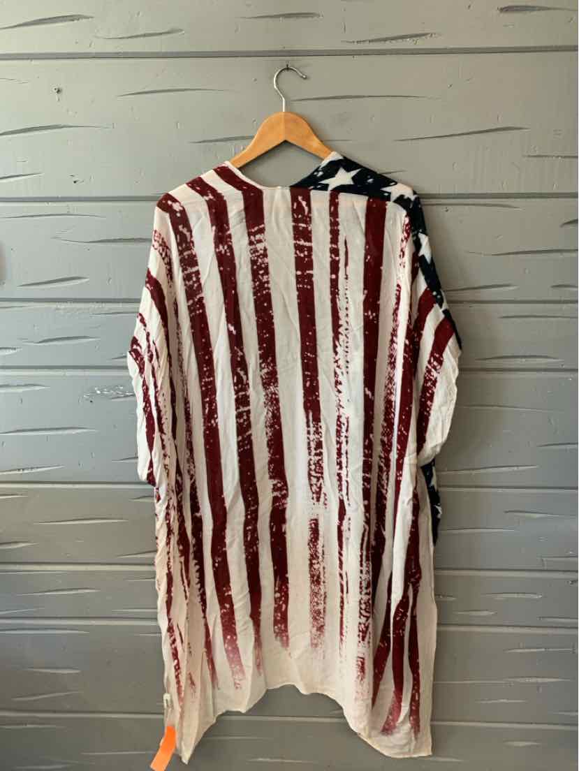 Oversized white tunic with distressed red vertical stripes and a black section with white stars on the shoulder.