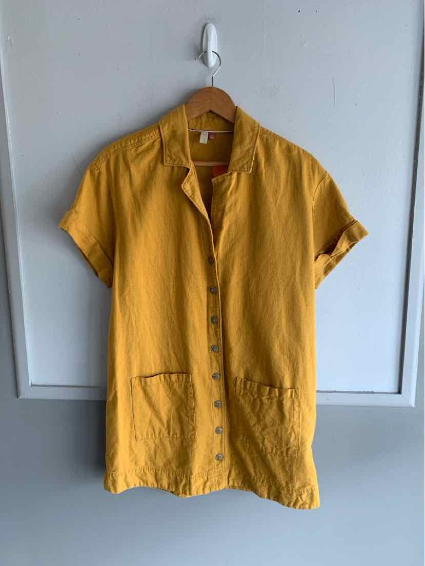 Mustard yellow short-sleeve button-up shirt with front patch pockets and a relaxed collar.