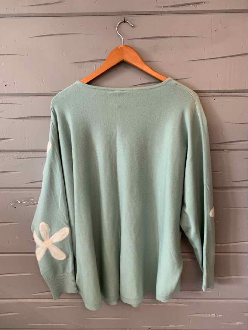 Sage green long-sleeve sweater with white daisy flower accents on sleeves, relaxed fit, size 2X.