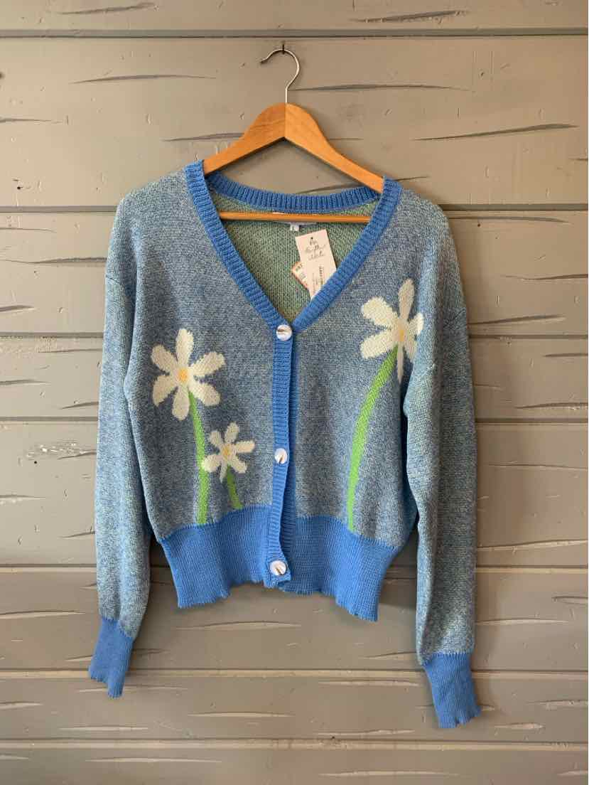 Light blue knit cardigan with blue trim, white and yellow floral embroidery, and front buttons.