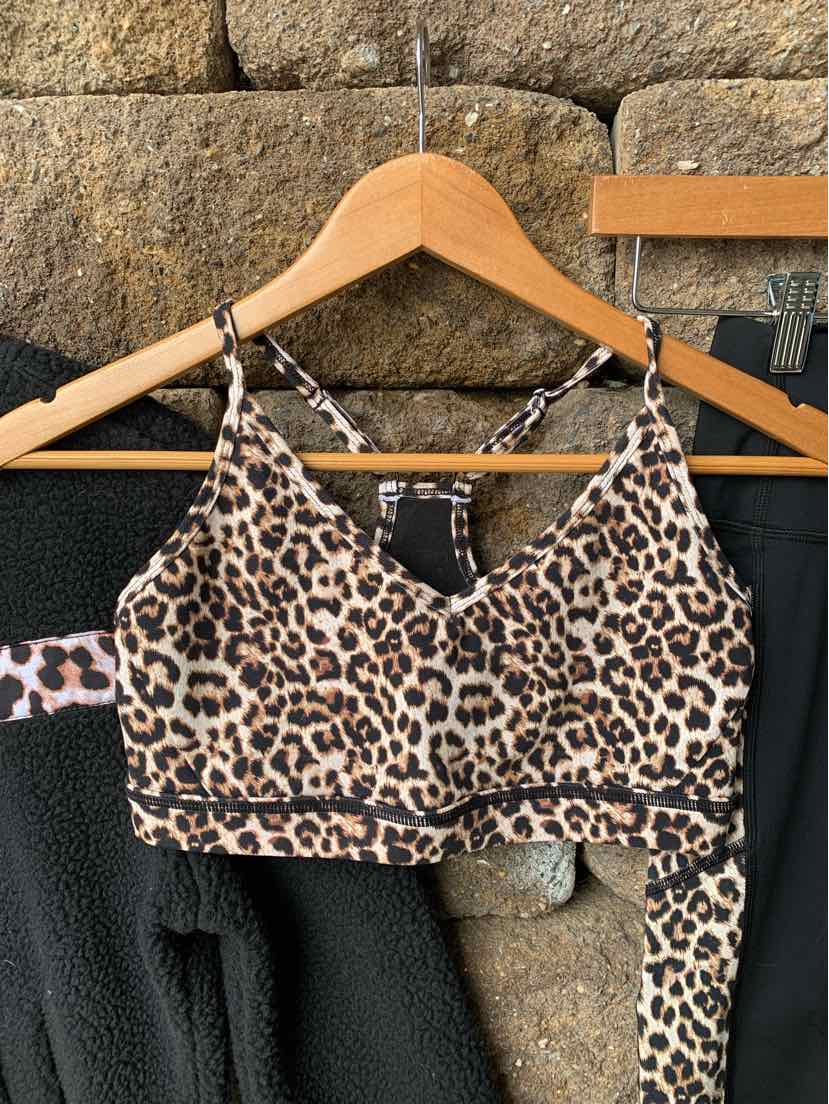 Leopard print sports bra with thin adjustable straps and a supportive band in size XS.
