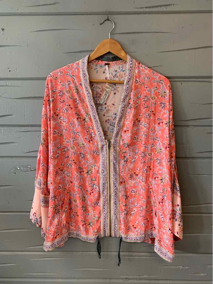 Pink floral lightweight cardigan with long sleeves and front zipper on wooden hanger.