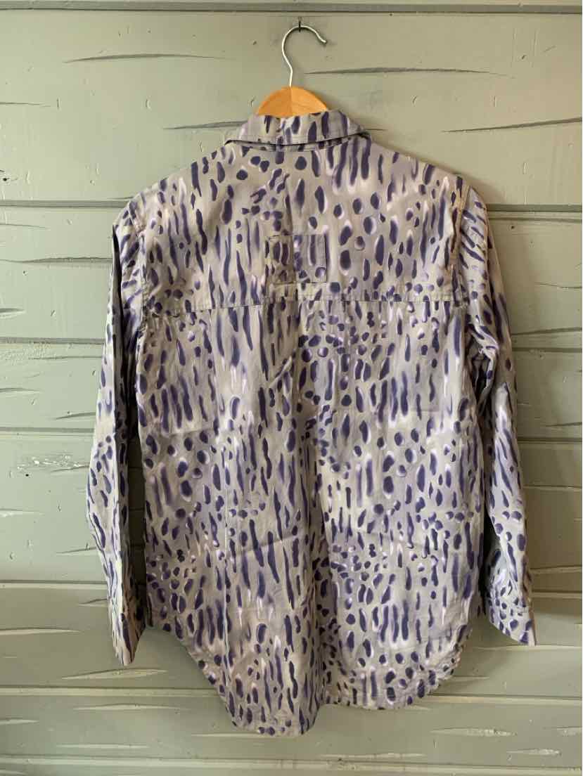 Long-sleeve button-up shirt with gray base and dark blue abstract animal print hanging on wooden hanger.