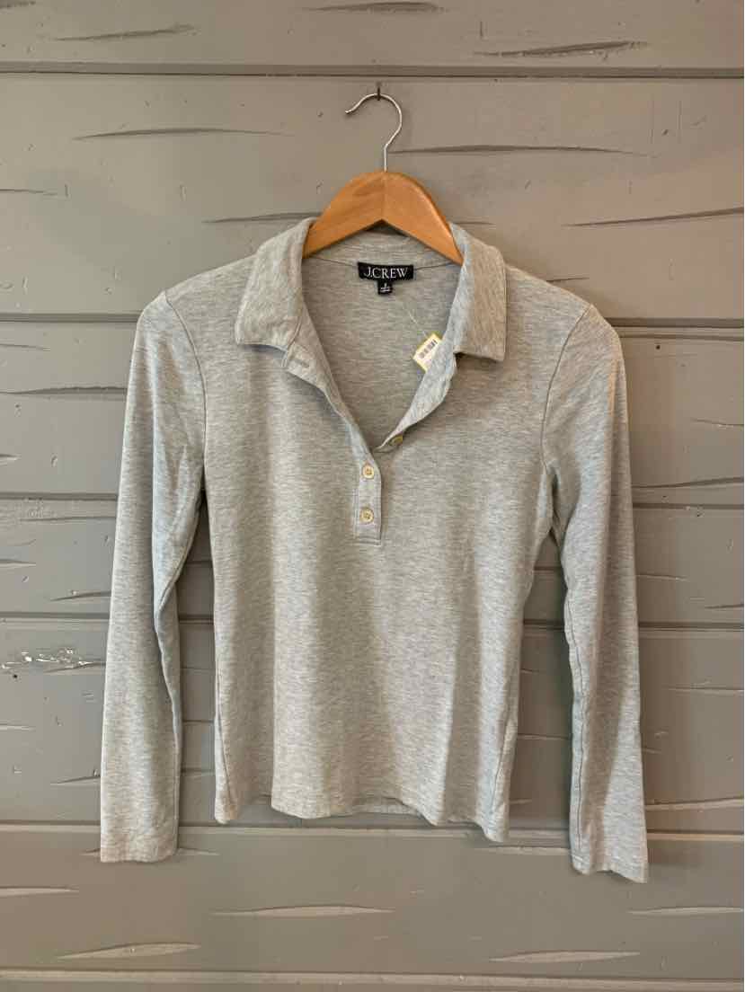 Light gray long-sleeve polo shirt with a soft texture and three-button placket on a wooden hanger.