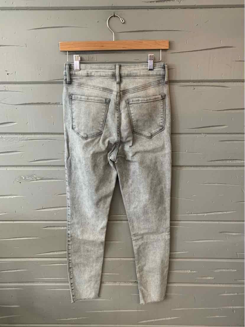 Light gray Old Navy denim jeans size 6 hanging on wooden hanger, rear view.
