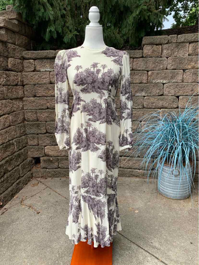 Long-sleeve white dress with purple floral print, square neckline, fitted waist, and ruffled hem.