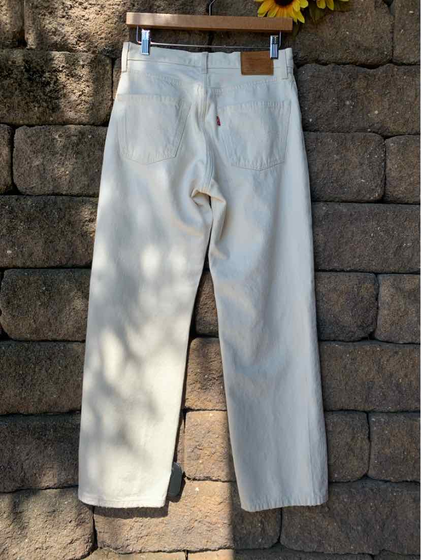 Off-white straight-leg denim pants with classic five-pocket design and leather brand patch on waistband.