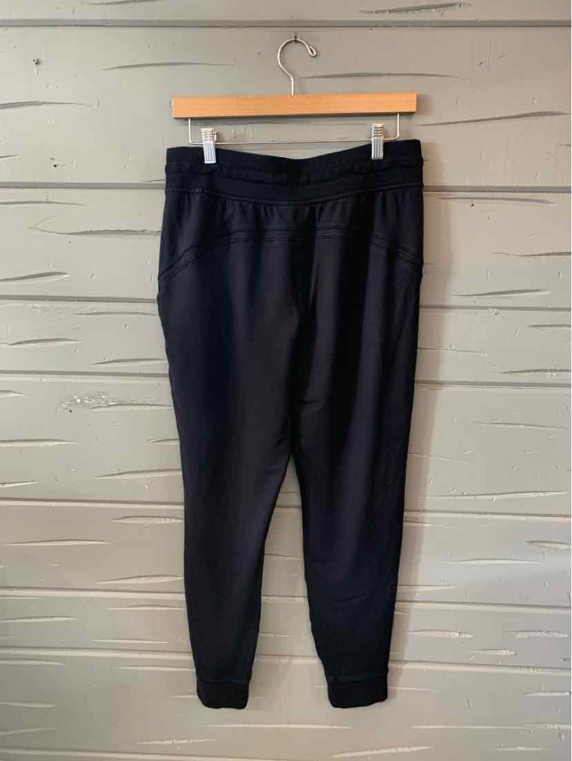 Black high-waist jogger pants with ribbed cuffs and side pockets, size 8.