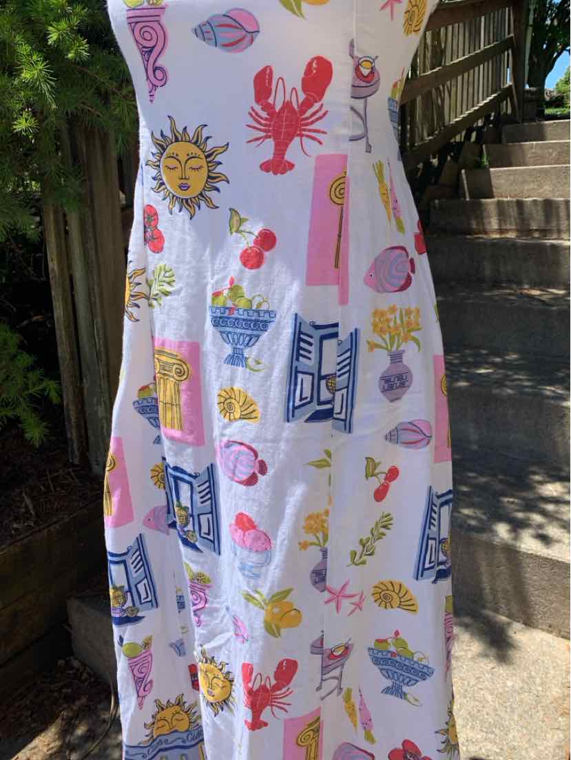 White sleeveless dress with colorful summer-themed prints including lobsters, suns, drinks, and geometric patterns.