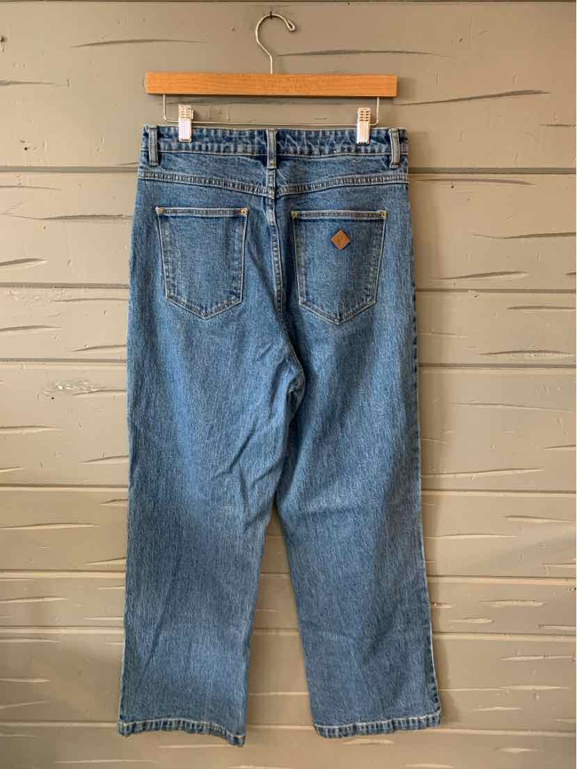 Mid-blue denim jeans with a relaxed straight leg fit, featuring two back pockets and belt loops.