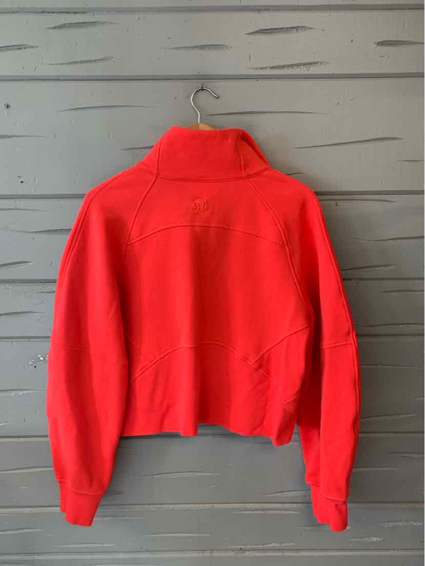 Bright red Lululemon zip-up jacket with a high collar, long sleeves, and a cropped fit.