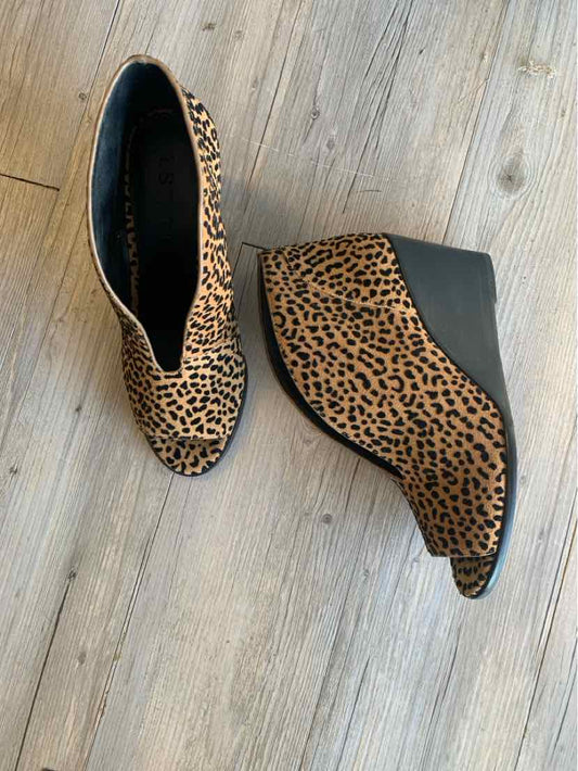 Women’s leopard print wedge ankle boots with black platform soles, size 9.5.