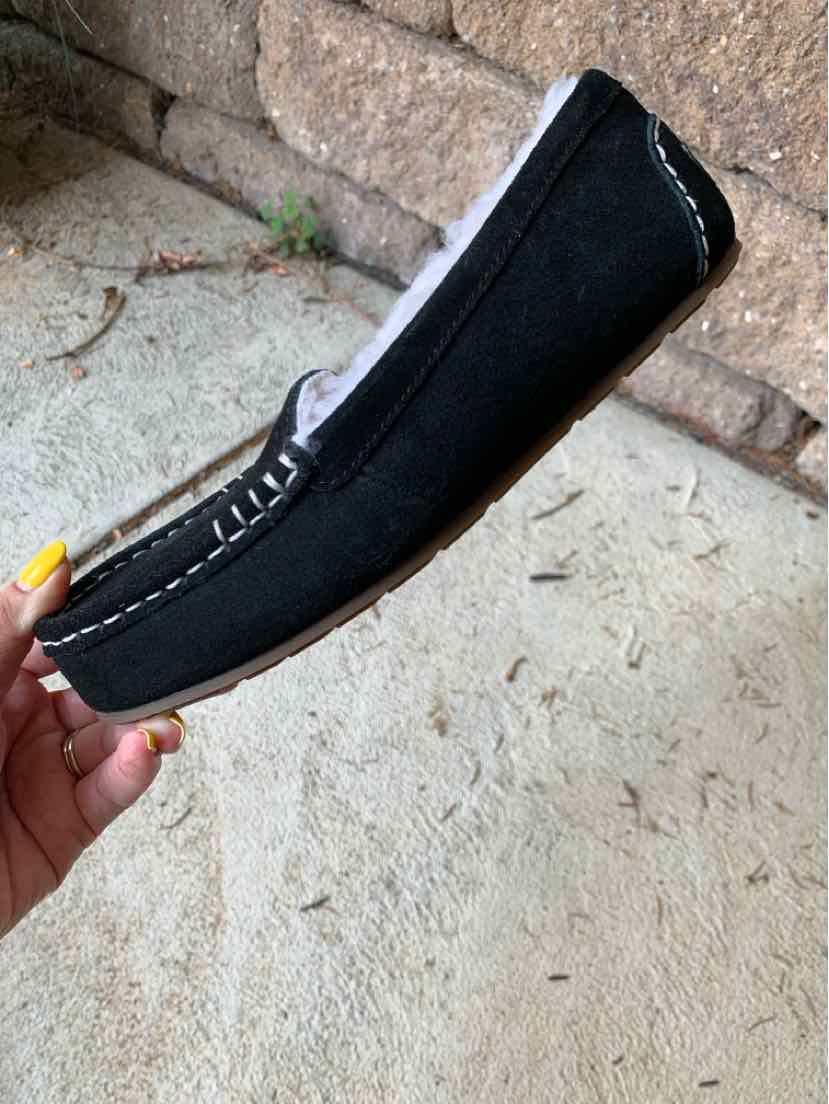 Black suede moccasin shoe with white stitching and rounded toe, size 6.