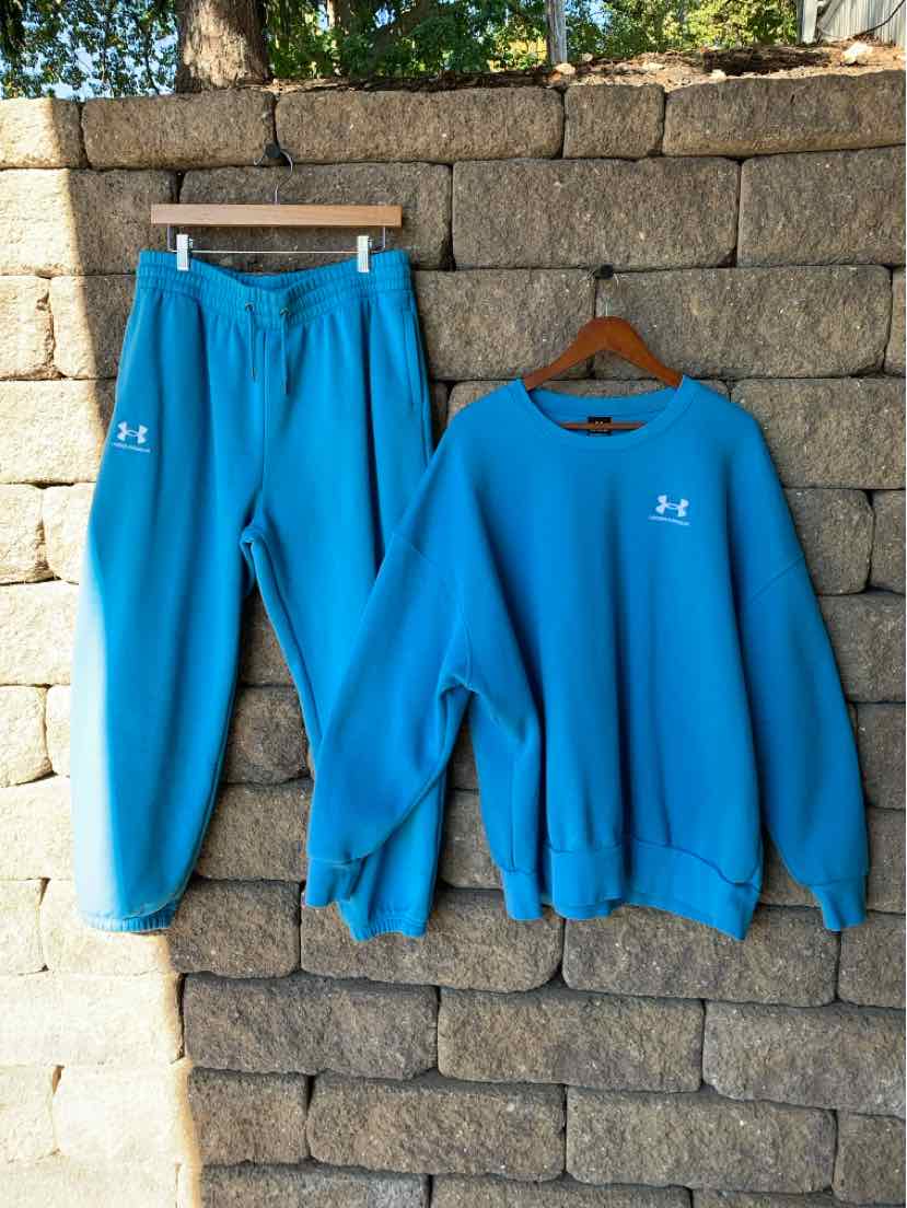 Bright blue Under Armour two-piece set with a crewneck sweatshirt and matching elastic-waist pants.