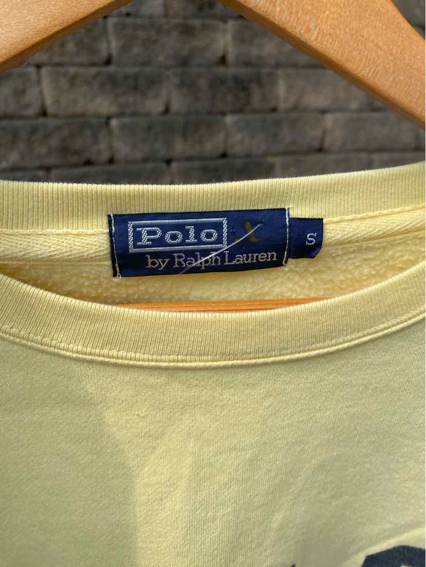 Light yellow cotton Polo by Ralph Lauren t-shirt with navy blue brand label and small size tag.