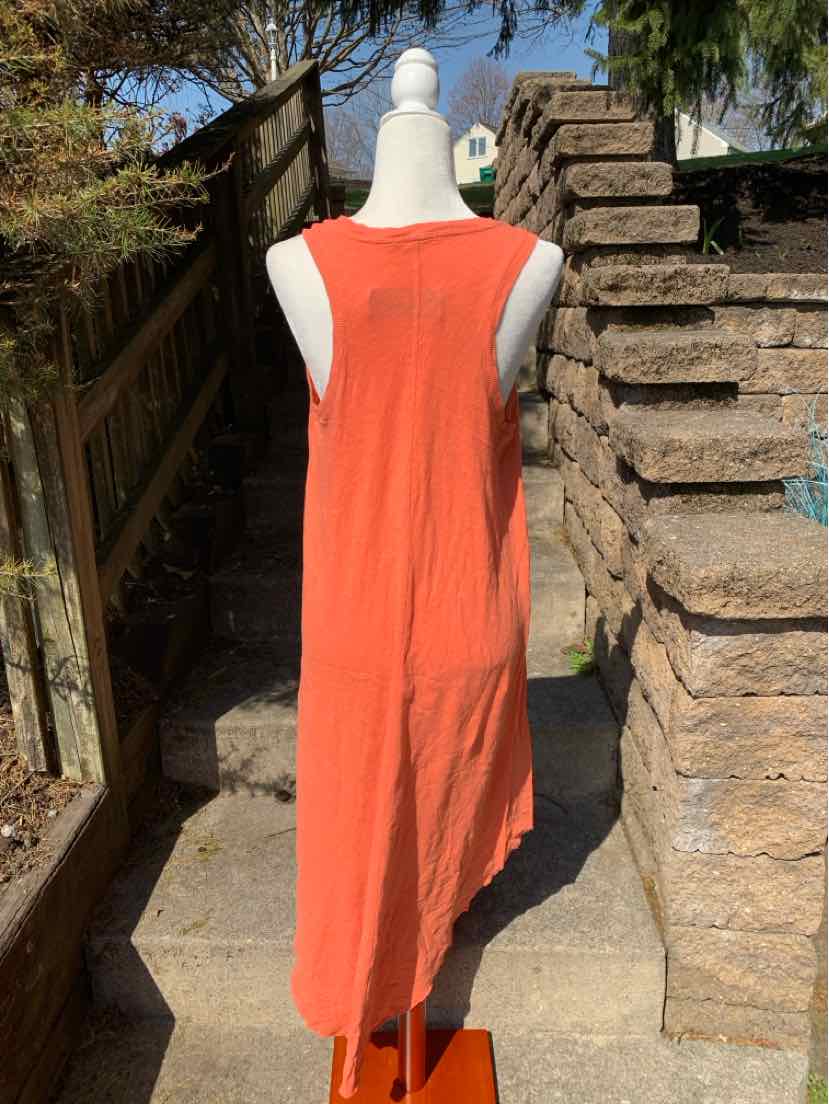 Orange sleeveless midi dress with round neckline on white mannequin outdoors.