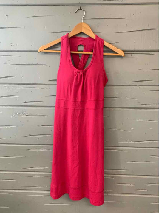 Pink sleeveless knee-length dress with racerback and keyhole front detail.