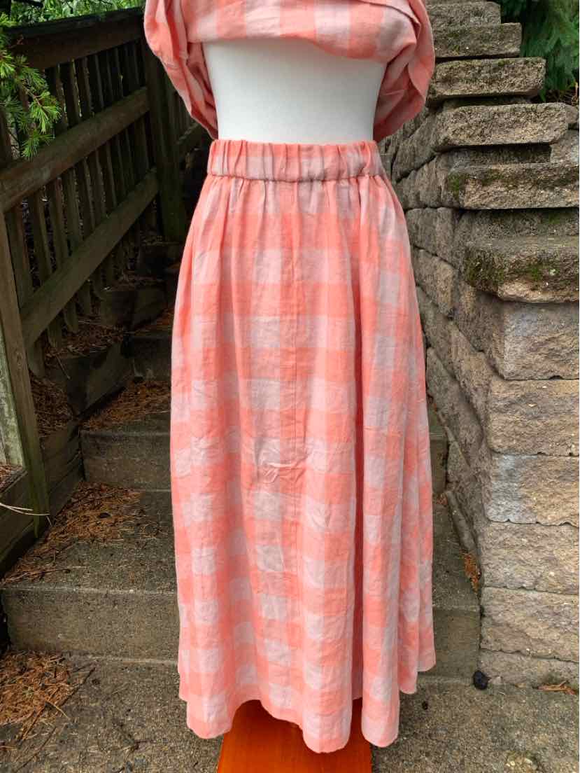 Coral and white gingham check midi skirt with elastic waistband on mannequin.