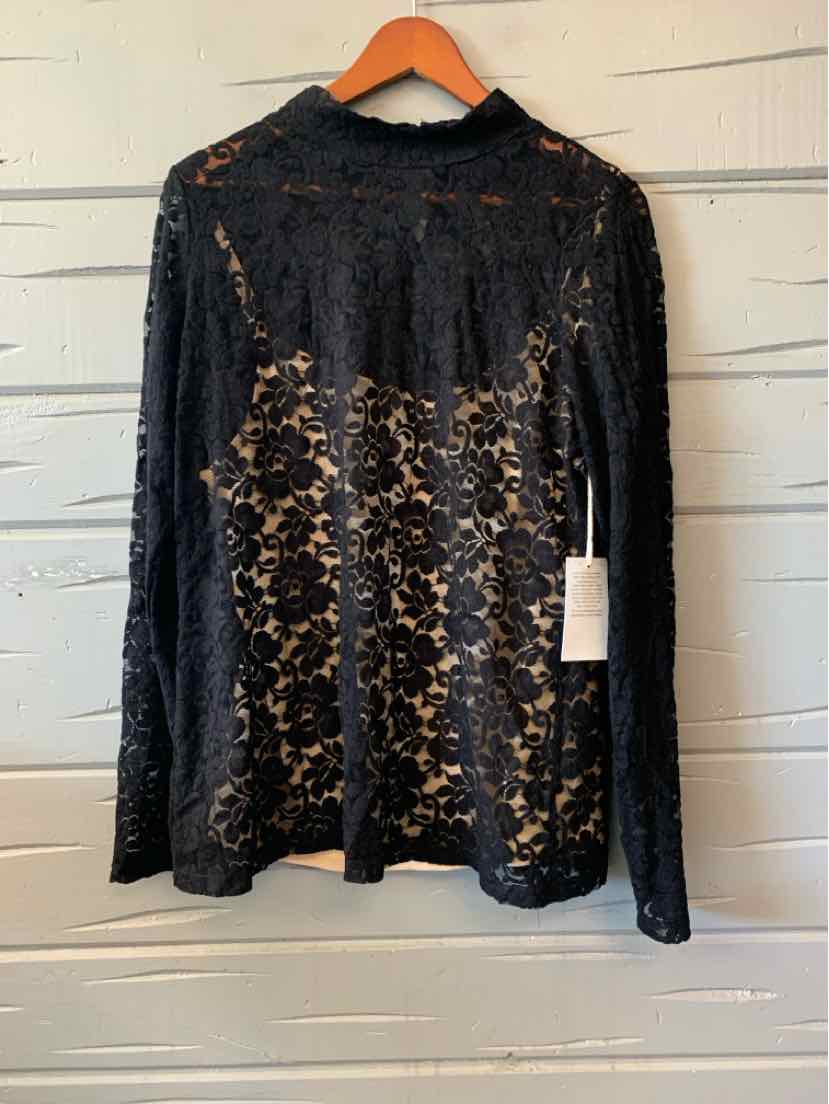 Black lace long-sleeve women's casual top with floral pattern hanging on wooden hanger.