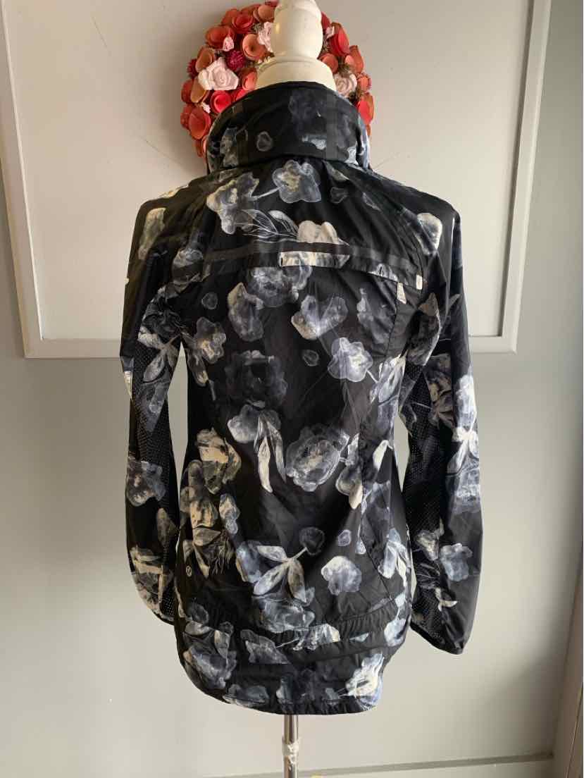 Black Lululemon jacket with white and gray floral pattern, size 4, high collar back view.
