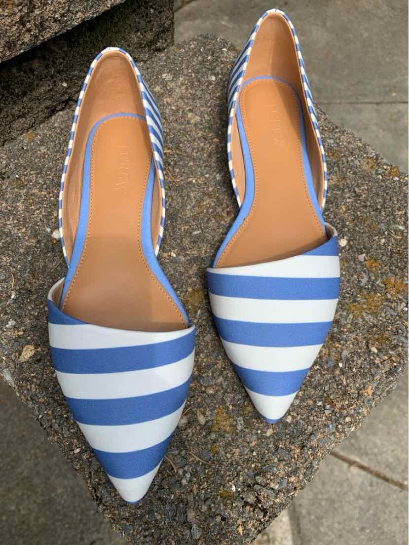 Blue and white striped pointed-toe flat shoes with tan insoles and slingback straps.