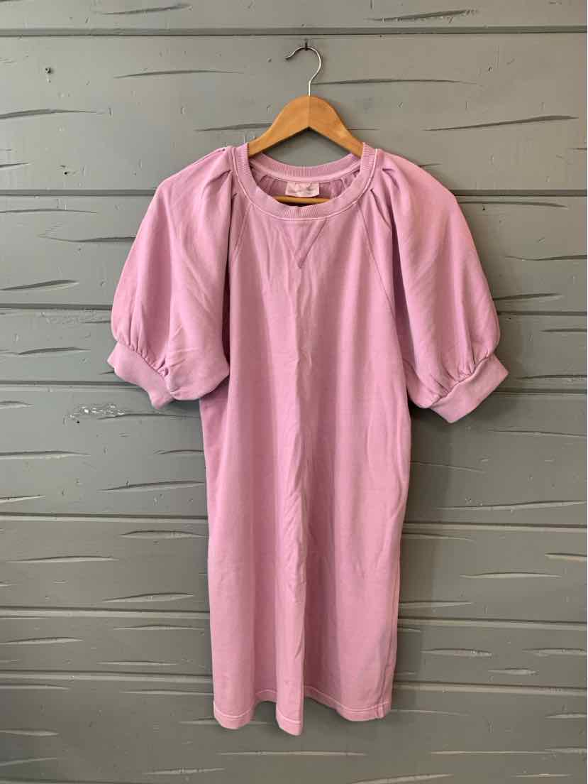 Soft pink knee-length dress with puffed short sleeves and gathered neckline on wooden hanger.