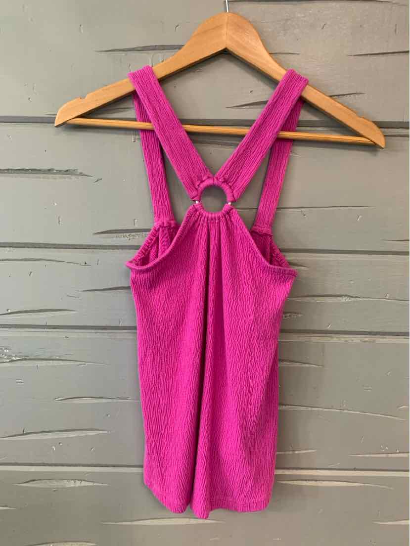 Bright pink sleeveless top with ring detail and crisscross straps on back, size XS.