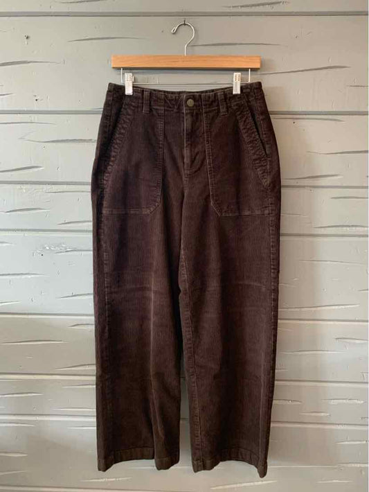Dark brown corduroy pants with a high waist and wide legs, featuring front patch pockets.